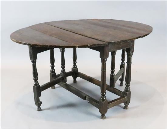 An early 18th century oak oval topped gateleg dining table, 4ft 4in. x 3ft 3in. H. 2ft 3in.